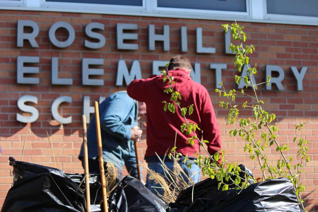 Two volunteers gardening at elementary school.